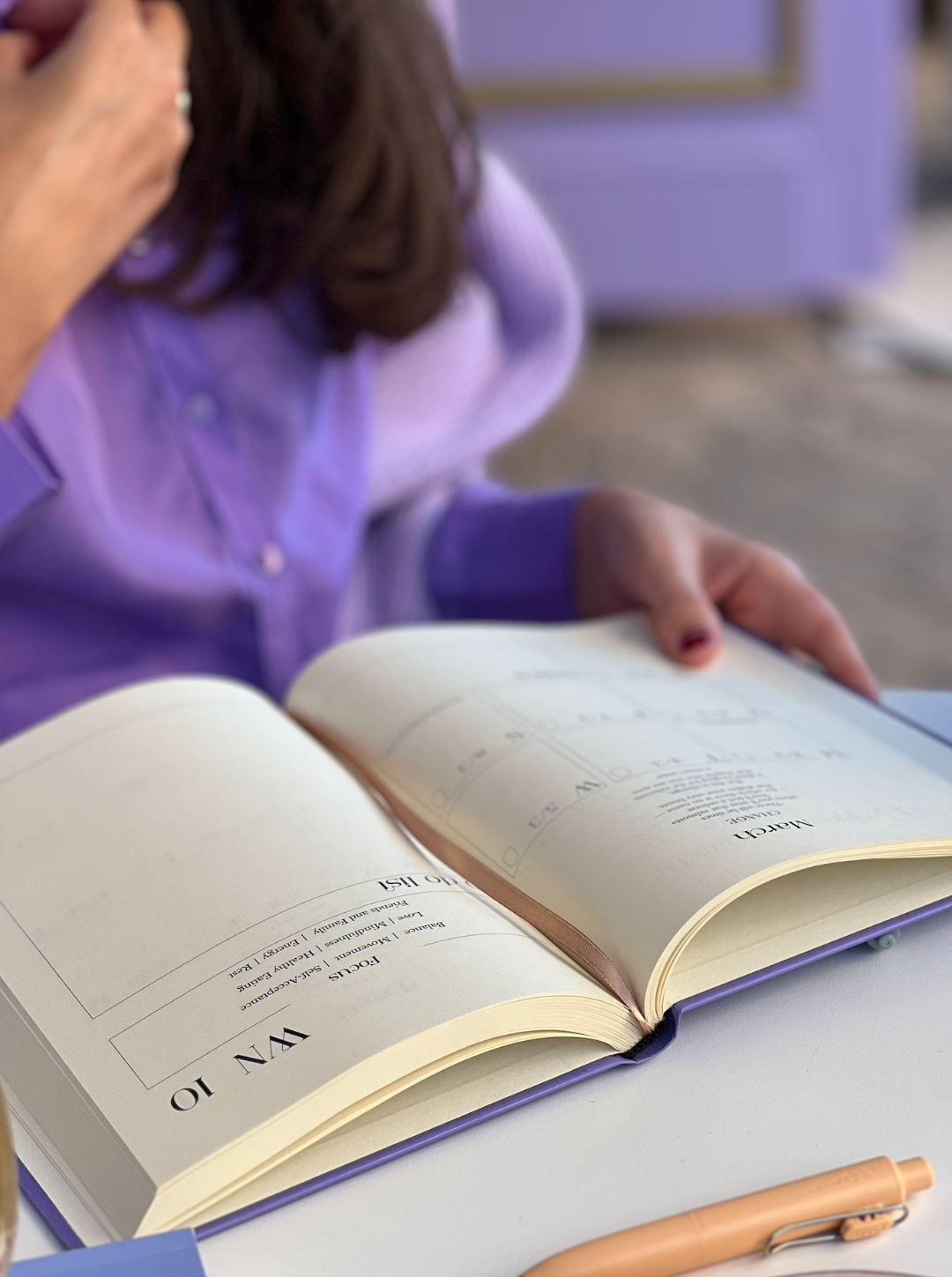 A girl organize her weekly planner in purple