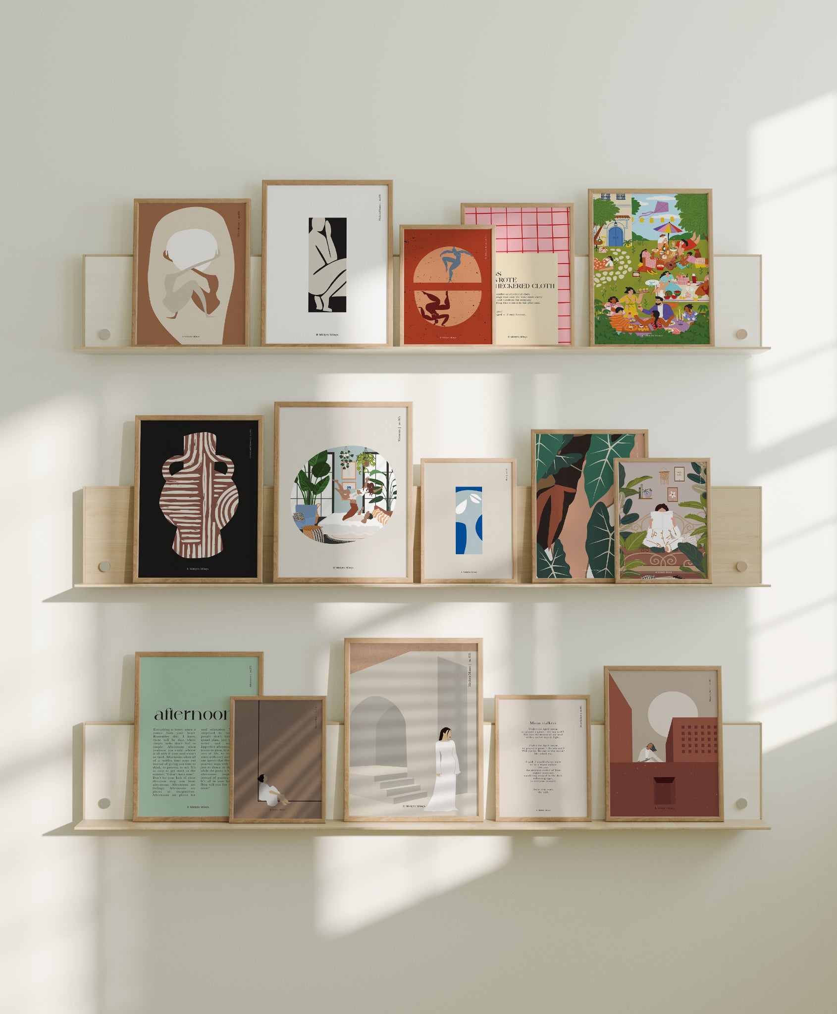 Shelves with framed artworks @11modernmuses on a light-colored wall
