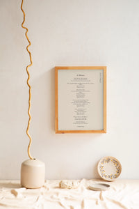 A wooden frame of a poemprint "a Minuet" to inspire you daily