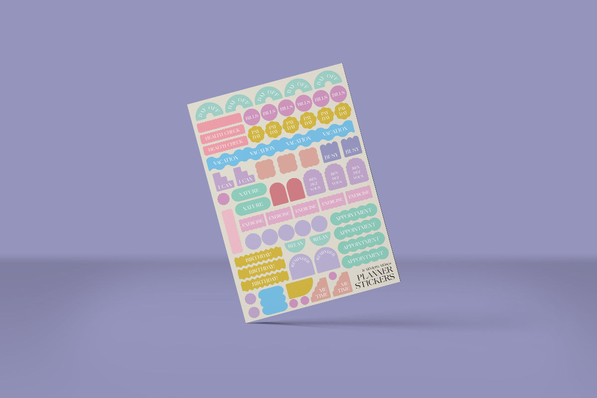 Sheet of colorful planner stickers on a purple background