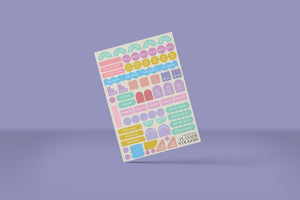 Sheet of colorful planner stickers on a purple background